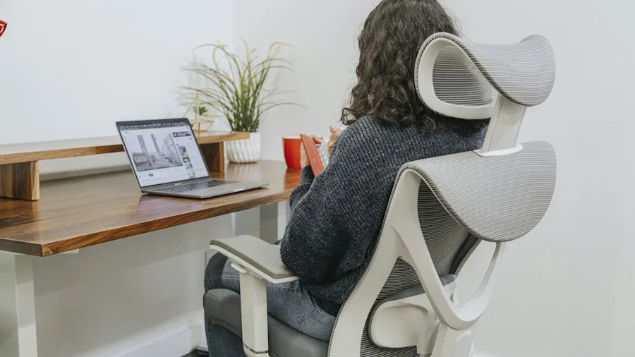 Professional reviewing their desk setup and posture to assess ergonomic needs for workspace improvements